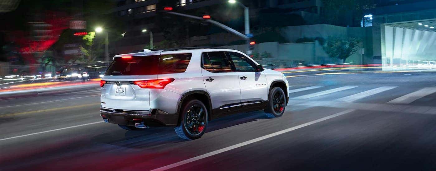 White 2023 Chevy Traverse for sale on a test drive at night