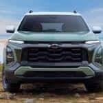 Front of a green 2026 Chevy Equinox parked off-road.