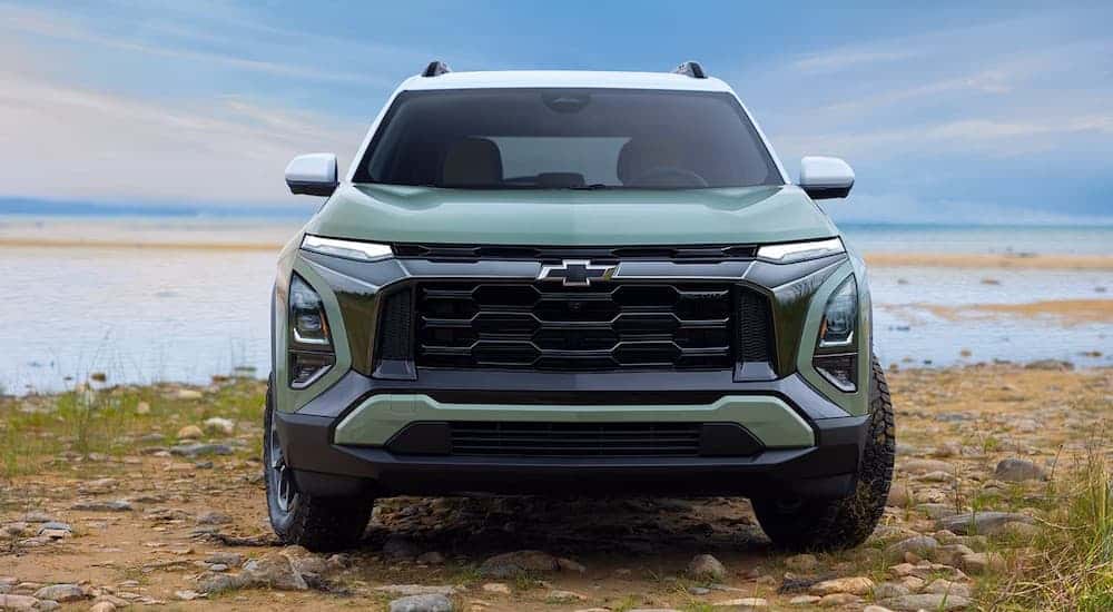 Front of a green 2026 Chevy Equinox parked off-road.