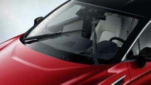 Red Honda with windshield wipers on