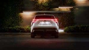 White Toyota RAV4 Prime XSE from behind at night with rear lights on