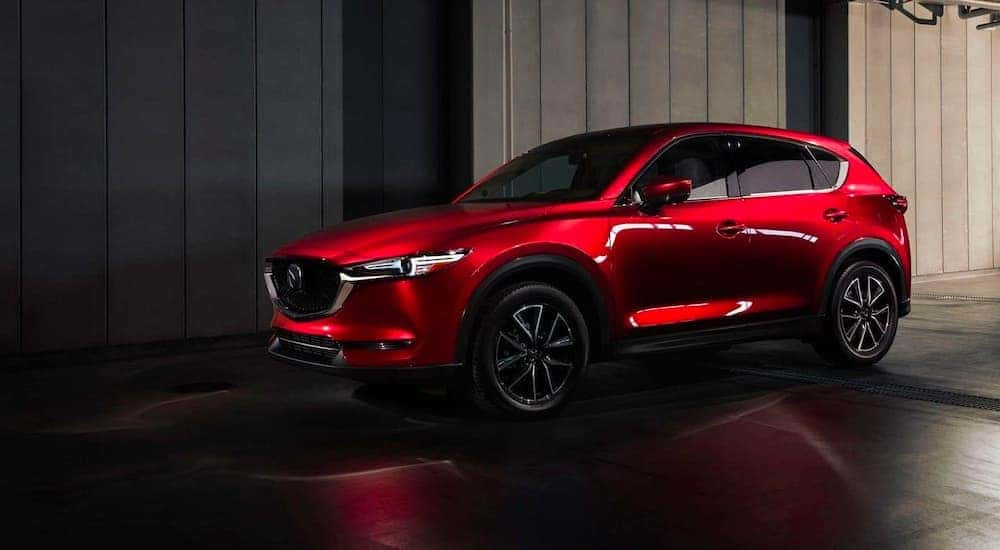 Red 2018 Mazda CX-5 parked in a showroom.
