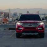 A red 2021 Ford Explorer is shown from the front overlooking a city after looking at used cars near you.