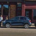 A grey 2020 Chevy Trax is shown from the side while parked on a street after leaving a used car dealership.