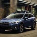 A blue 2023 Subaru Crosstrek is shown from the front at an angle after leaving a used car dealership..