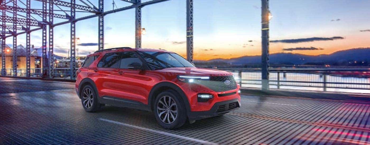 A red 2021 Ford Explorer ST is shown from the front at an angle after leaving a used car dealership near me.