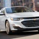 A white 2021 Chevy Malibu is shown from the front at an angle.