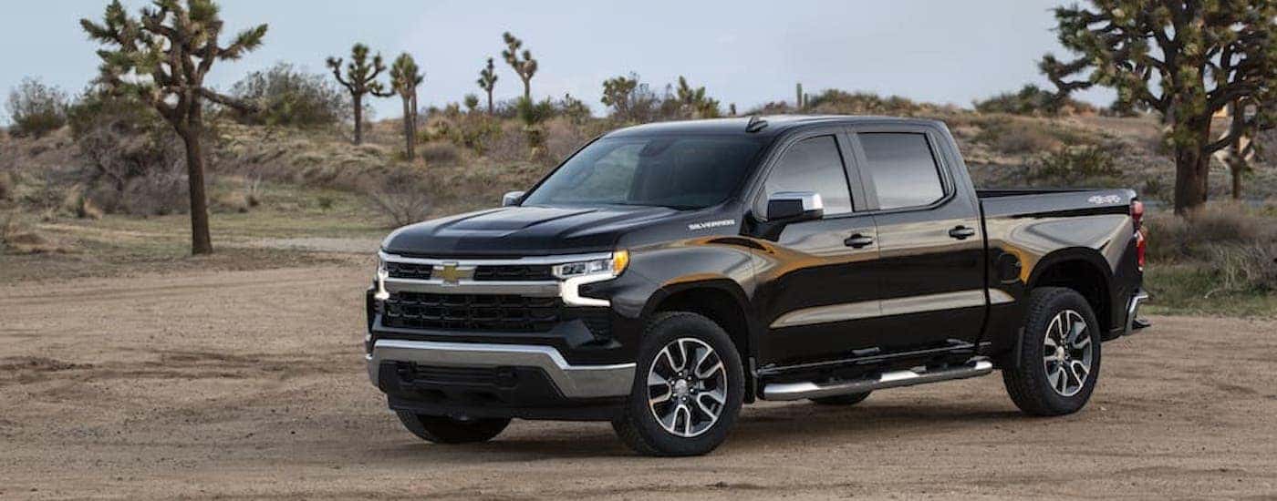 A black 2022 Chevy Silverado 1500 LT is shown from the front at an angle.
