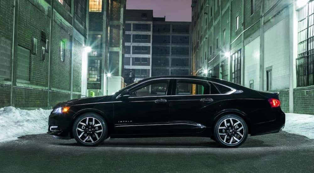 Black 2018 Chevy Impala Midnight Edition parked in an alleyway.