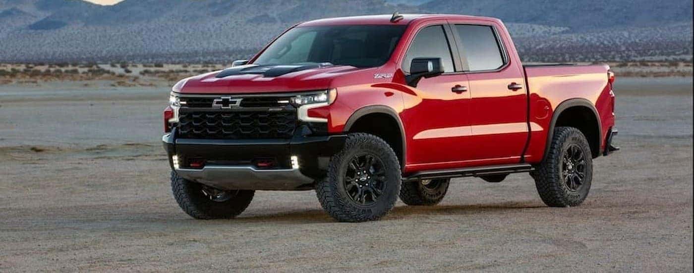 A red 2022 Chevy Silverado 1500 ZR2 is shown parked off-road.