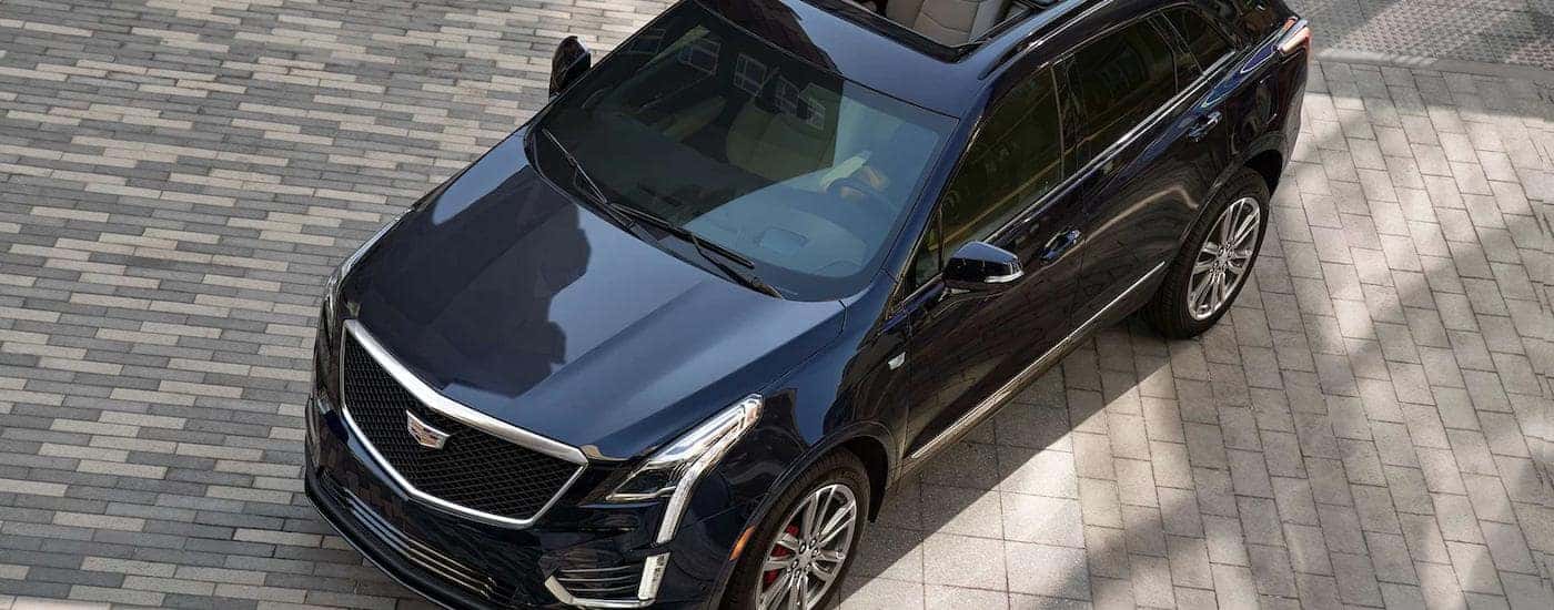 A dark blue 2022 Cadillac XT5 is shown from a high angle on a brick road.