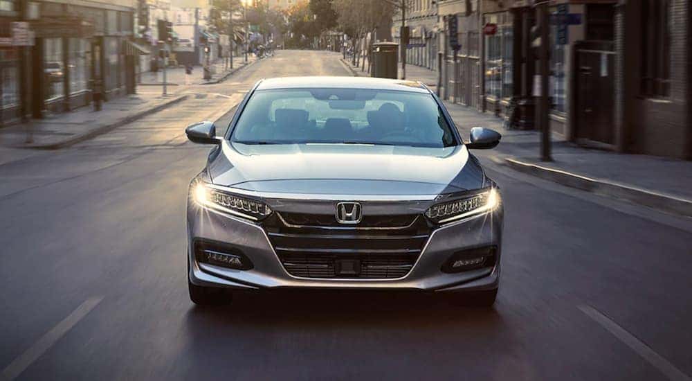 Silver 2020 Honda Accord driving down a city street.