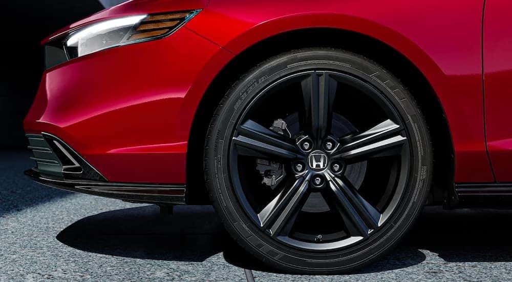 Front wheel of a red 2023 Honda Accord Sport L Hybrid.