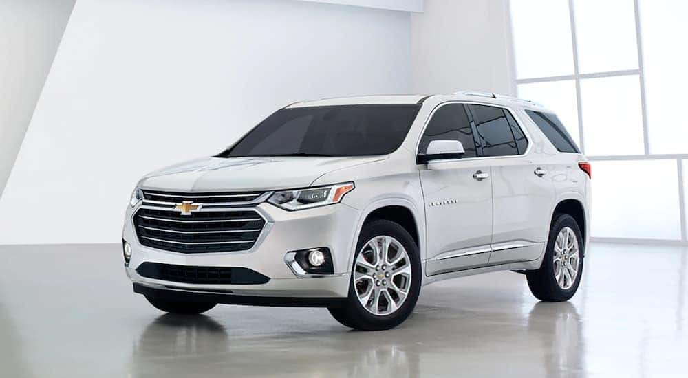 A white 2020 Chevy Traverse is shown parked on a showroom floor.