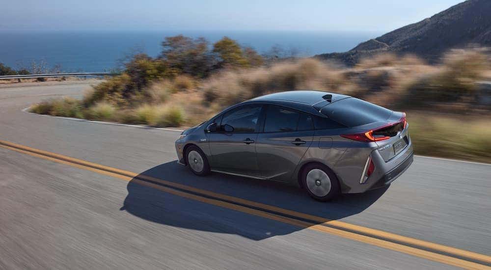 Grey 2020 Toyota Prius Prime driving to view used cars for sale near Troy.