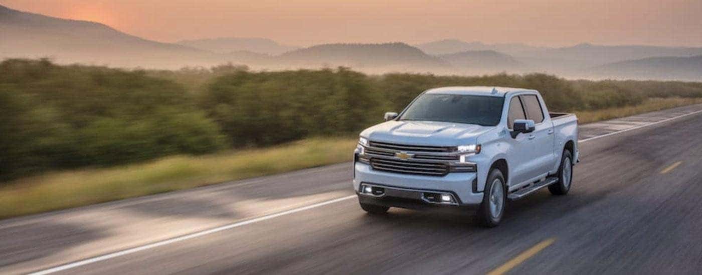 White 2021 Chevy Silverado 1500 driving on an open highway