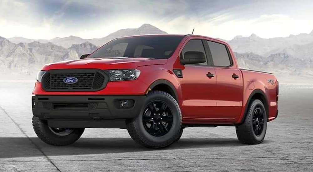 A red 2023 Ford Ranger STX is shown parked near a mountain range.