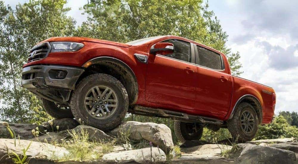 Red 2023 Ford Ranger parked on a pile of boulders.