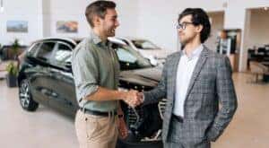 Two people are shown shaking hands.