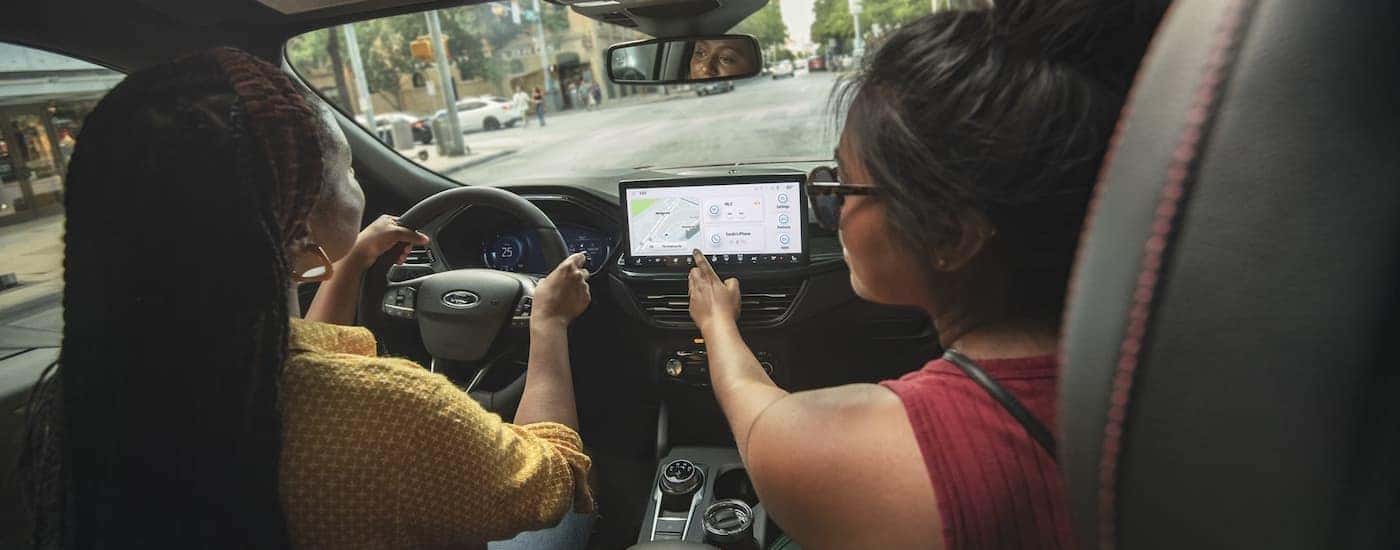 The black interior and dash are shown in a 2024 Ford Escape.