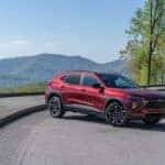 A red 2024 Chevy Trax from the side after leaving a dealer that has a Used Chevy for Sale in Albany.