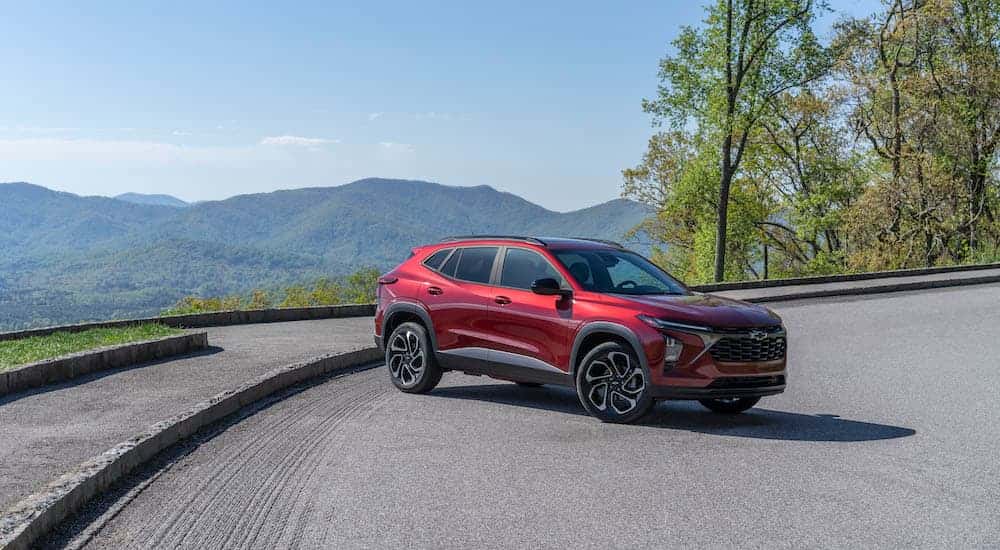 A red 2024 Chevy Trax from the side after leaving a dealer that has a Used Chevy for Sale in Albany.