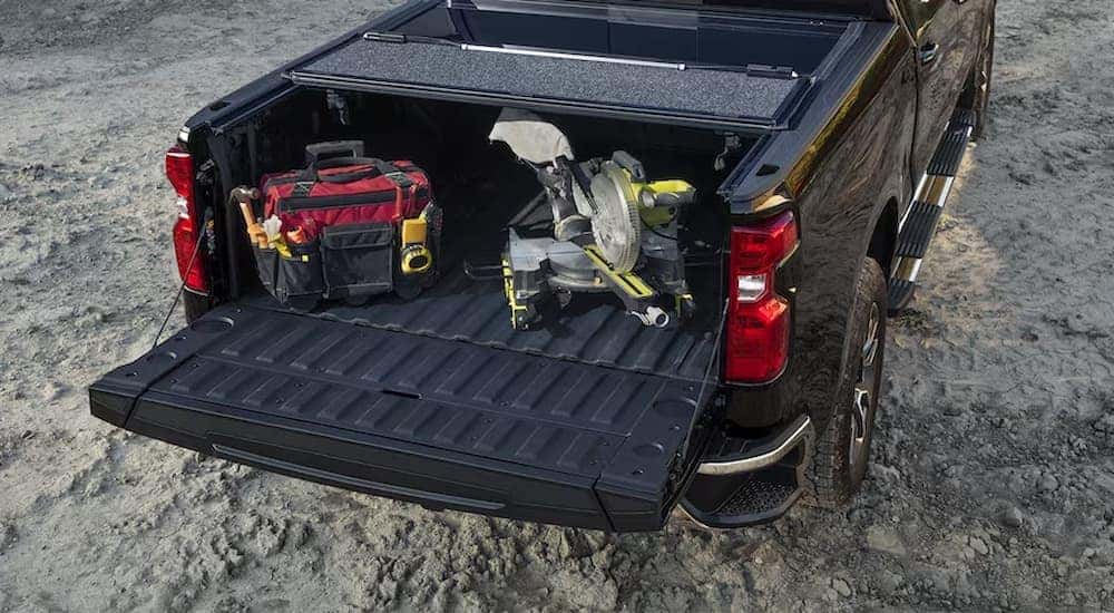 Tools in the bed of a black 2024 Chevy Silverado 1500.