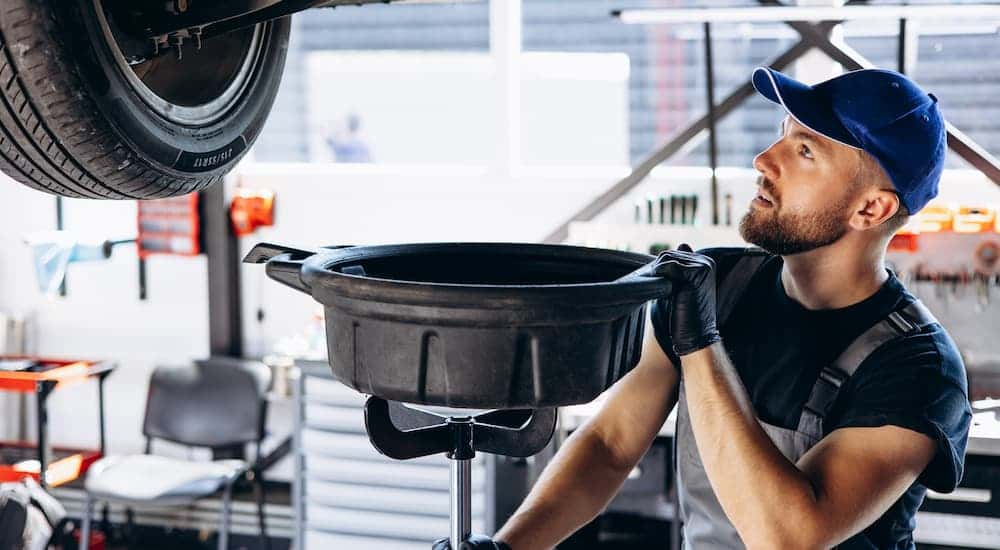 Man performing an oil change at a dealership