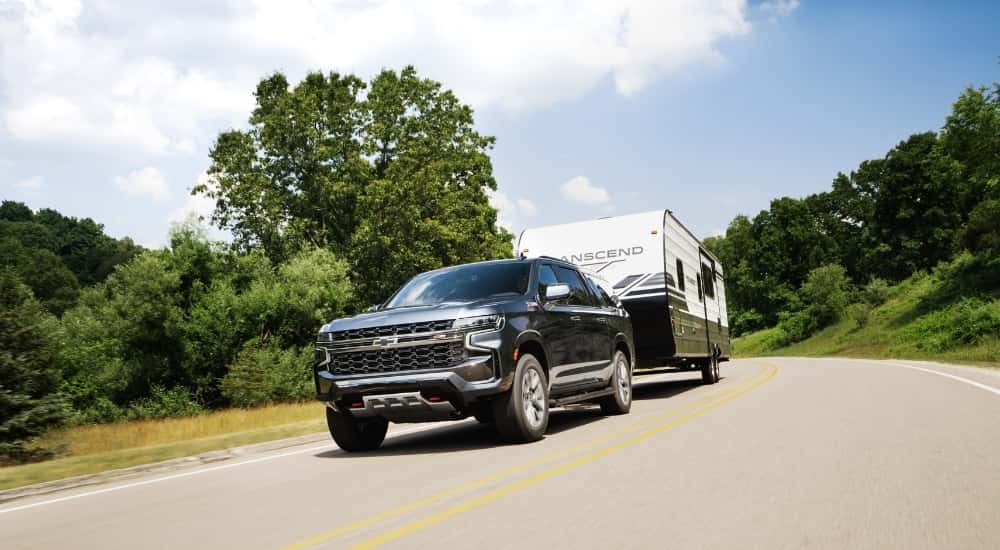 Grey 2023 Chevy Suburban Z71 towing a trailer
