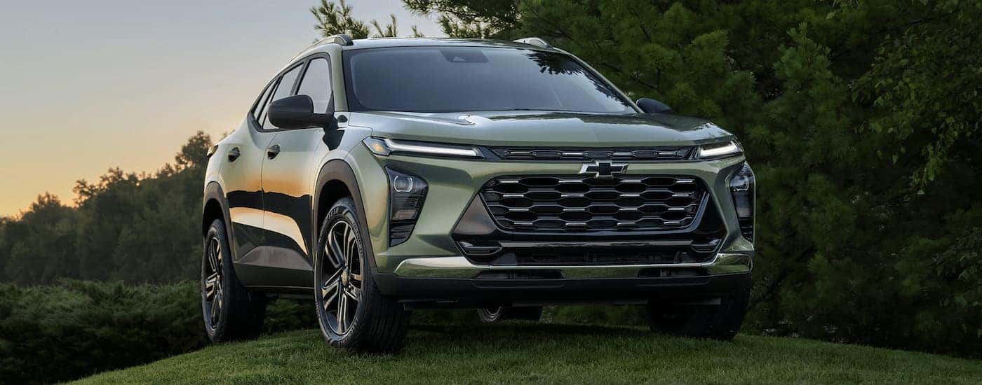 Green 2024 Chevy Trax parked on a grass hill
