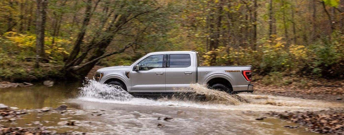 A silver 2021 Ford F-150 from the side.