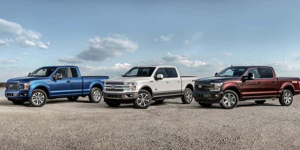 Three used 2018 Ford F-150's for sale near Schenectady parked side-by-side.