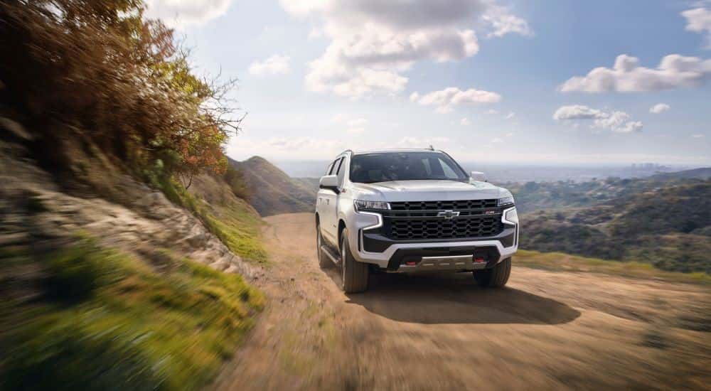 White 2021 Chevy Tahoe Z71 driving down a trail