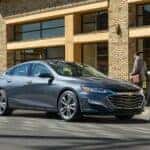 Grey 2020 Chevy Malibu driving through a city