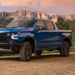 A blue 2024 Chevy Silverado 1500 ZR2 parked off-road.