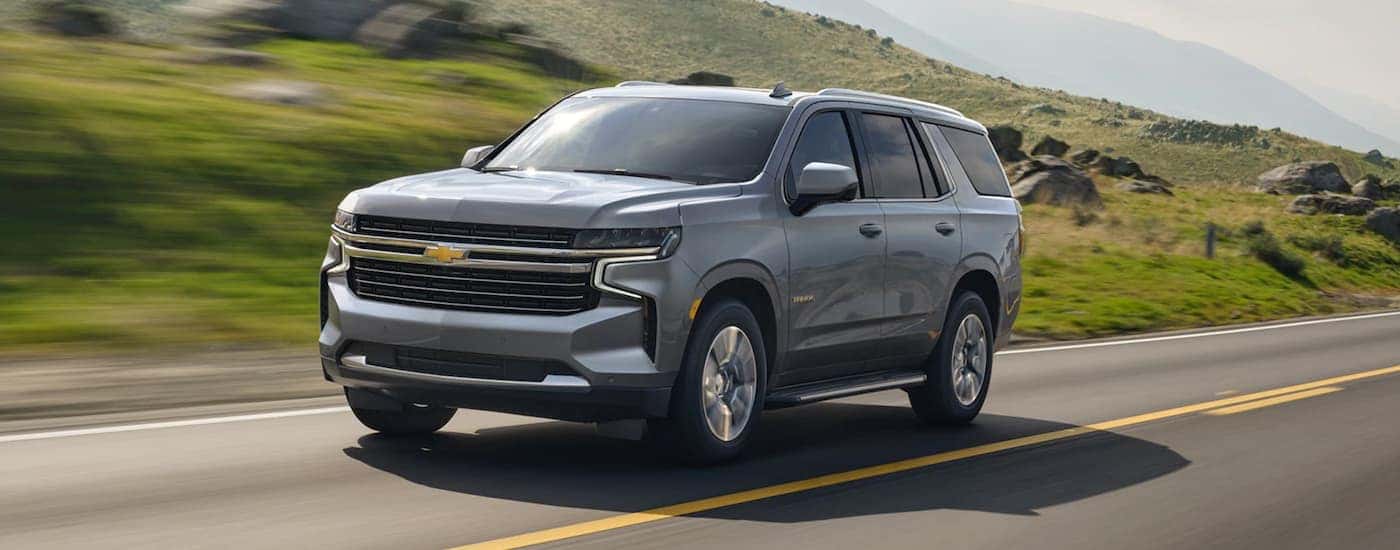 Silver 2021 Chevy Tahoe driving to see used Chevys for sale near Schenectady