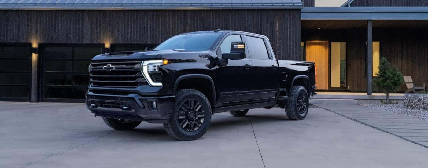 Black 2024 Chevy Silverado 2500 HD High Country parked at an angle