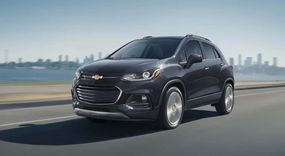 A gray 2020 Chevy Trax driving to view used SUVs for sale in Albany.