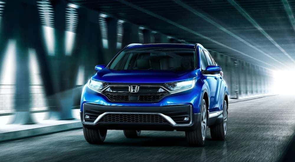 Blue 2020 Honda CR-V driving down a tunnel with a used SUVs for sale near Colonie.