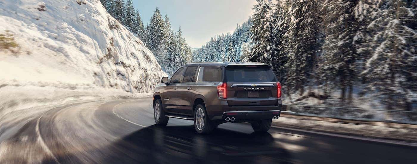 A grey 2024 Chevy Suburban from the rear.