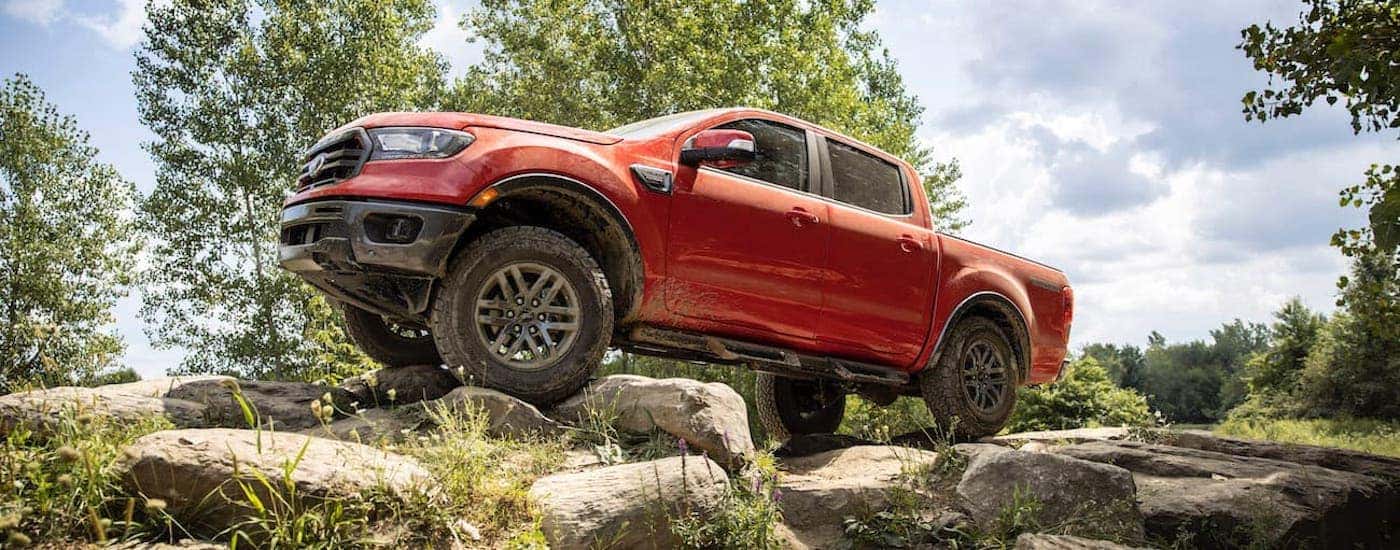 Red 2021 Ford Ranger parked off-road after visiting a dealer with used trucks for sale near Schenectady.
