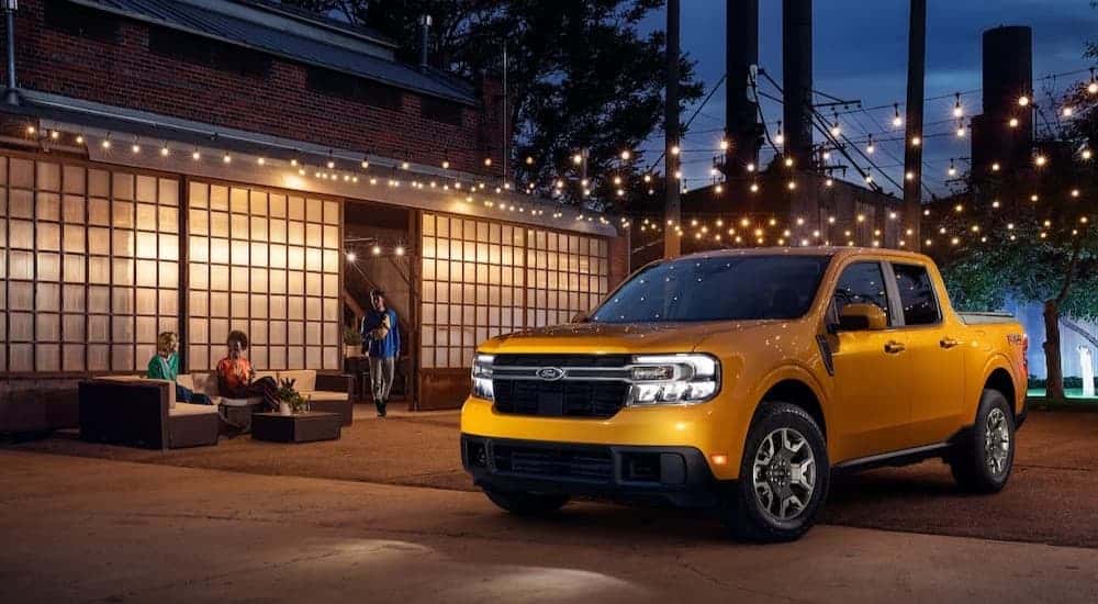 A yellow 2022 Ford Maverick parked at night.