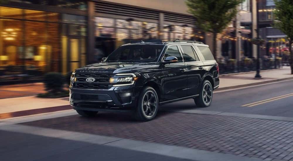 A black 2023 Ford Expedition Stealth Edition driving in a city