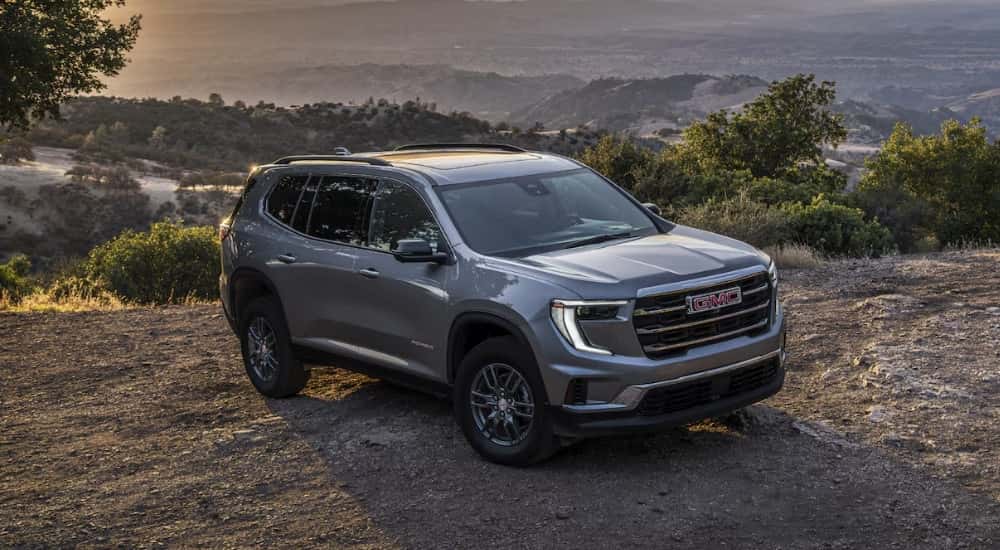 A gray 2025 GMC Acadia Elevation parked off-road