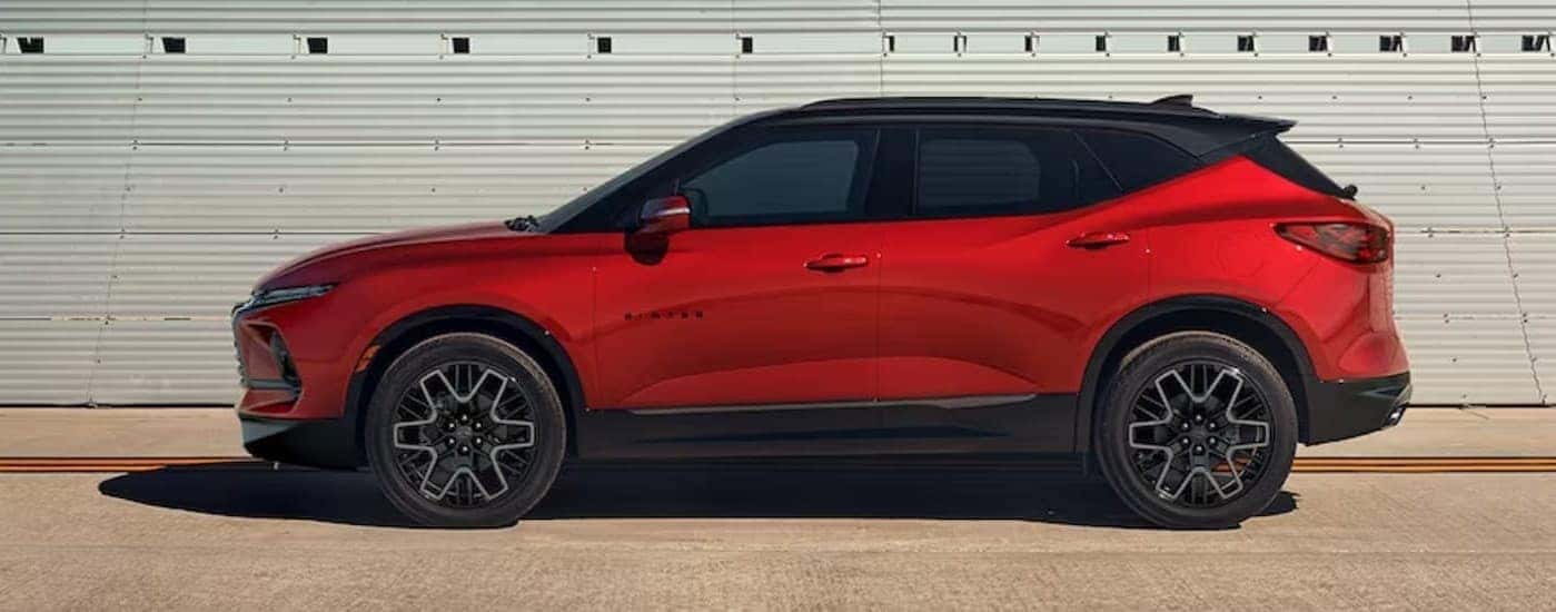 A red 2024 Chevy Blazer RS parked near bleachers.