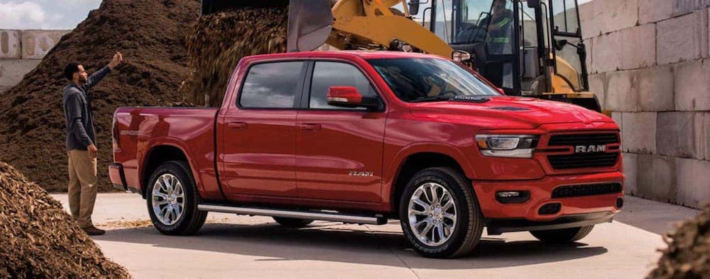 A red 2021 Ram 1500 is shown from the side.
