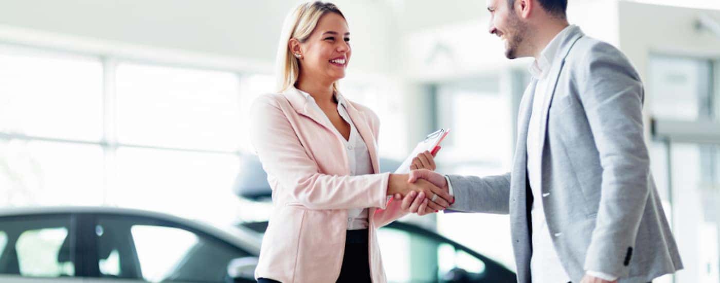 A salesperson is shown talking to a customer