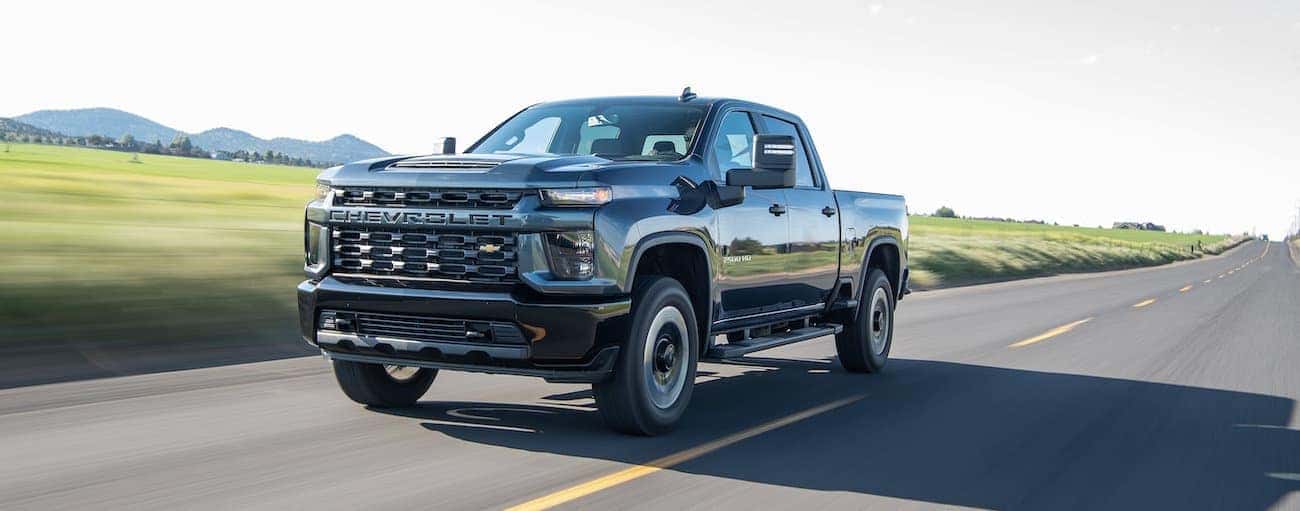 A black 2020 Chevy Silverado 2500 HD driving down a road.