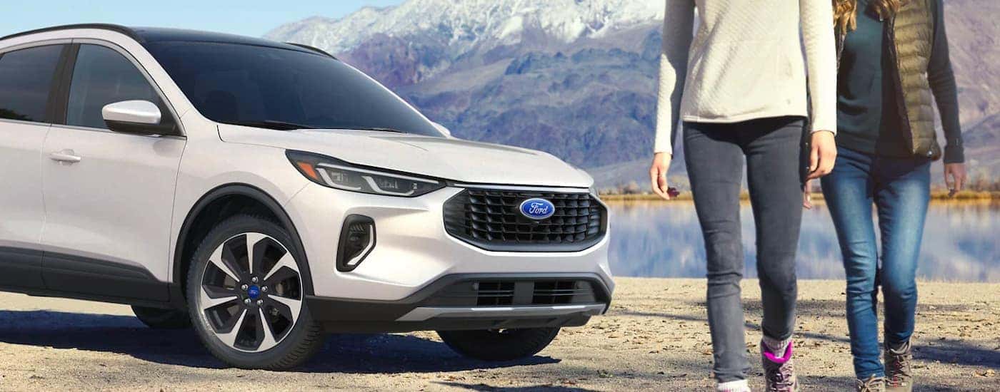 A white 2023 Ford Escape Platinum is shown parked by a lake