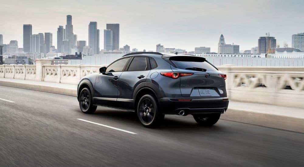Blue 2026 Mazda CZ-30 driving into the city